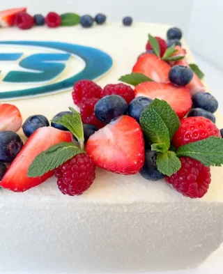 Cake with logo and fresh berry decor