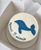 Torta bianca con balena blu e scritta
